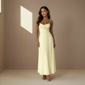 Pale yellow satin maxi dress with spaghetti straps and sweetheart neckline, front view with nude strappy heels